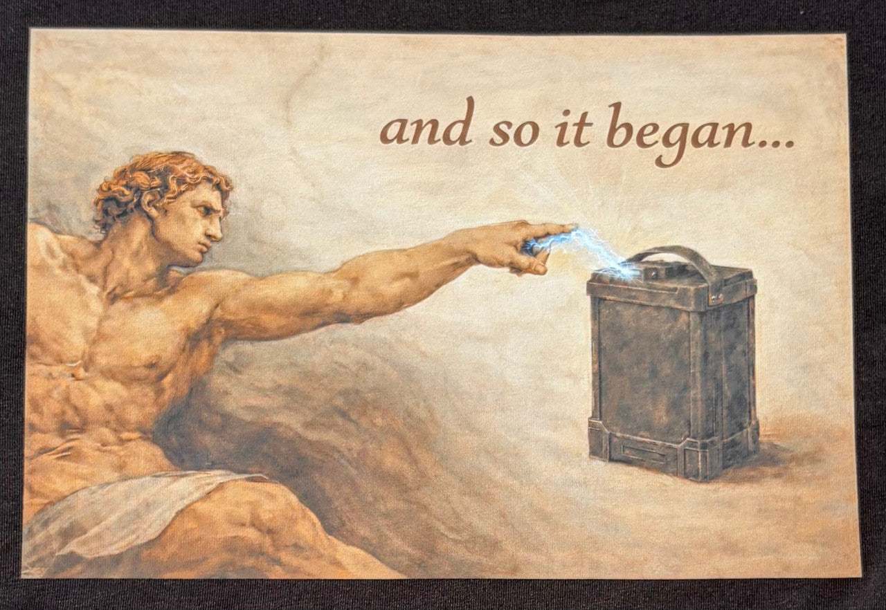 Featuring a rectangular graphic printed across the upper back. The image is styled like a classical painting and shows a muscular figure reaching out with an extended hand toward a battery-like object, with a small spark of electricity between them. Above the image, the text reads “and so it began…”.
