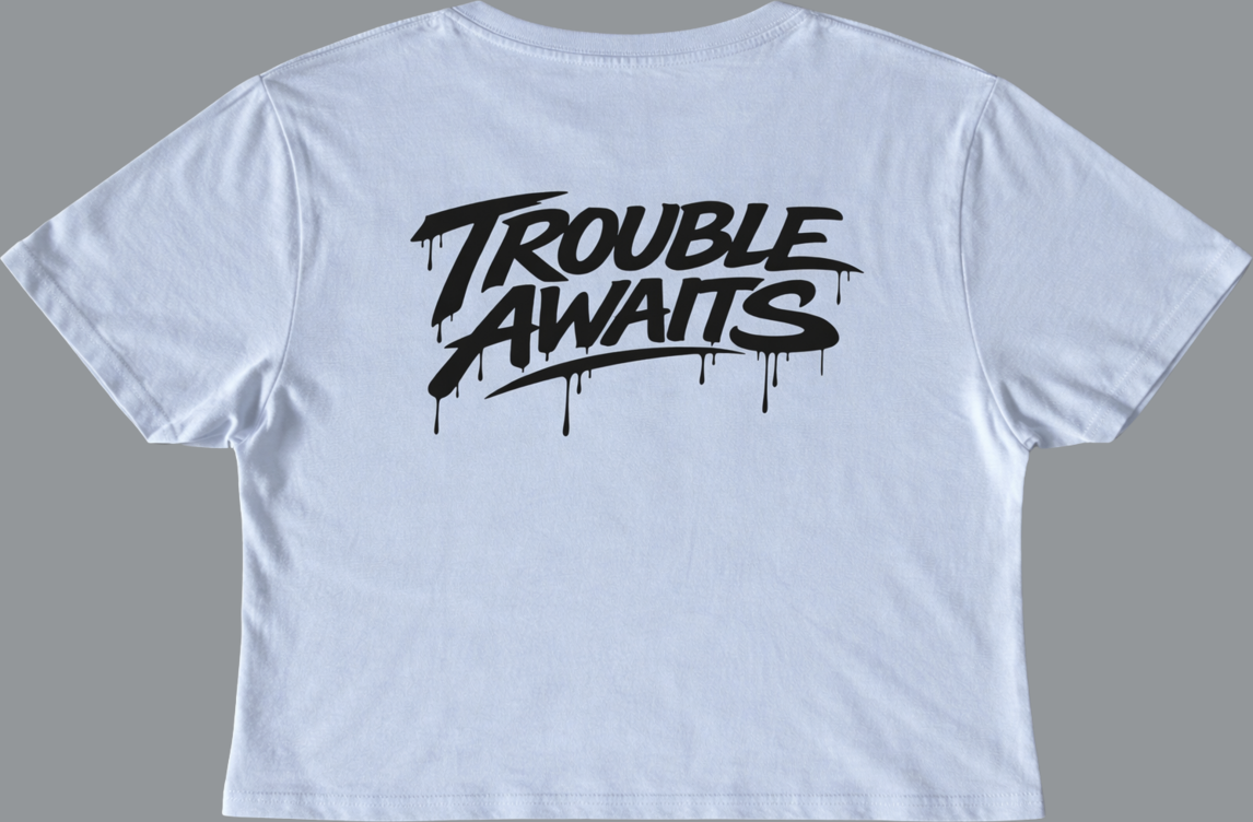 Back of light blue cropped t-shirt featuring black Trouble Awaits text logo with dripping graffiti design