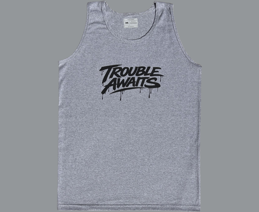 A sleeveless tank top is displayed flat against a plain gray background, shown from the front. The garment has a relaxed, straight fit with wide shoulder straps, large arm openings, and a rounded scoop neckline. A size label is visible inside the collar at the back of the neckline.

The fabric is heather gray, featuring a subtle mixed-tone texture typical of blended cotton materials. The surface appears soft with light
Centered across the chest is a large black logo