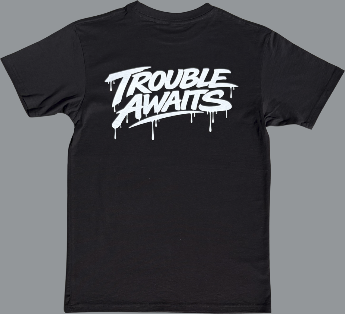 Black t-shirt with 'Trouble Awaits' text in white on a gray background