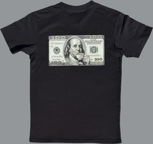 Black short sleeve t-shirt featuring a rectangular graphic printed across the upper back. The graphic resembles a United States $100 bill and includes a stylized image of Benjamin Franklin holding and sipping from a small teacup. The rest of the shirt is plain black with no additional visible graphics.