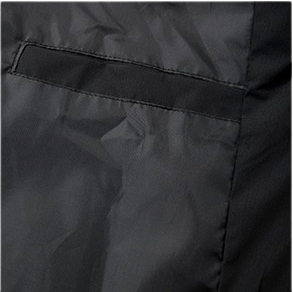 A close-up view of the inside of a black windbreaker shows a simple interior pocket. The pocket is stitched onto the inner lining with clean horizontal and vertical seams, forming a rectangular opening. The fabric appears lightweight with a slight sheen and visible creasing, consistent with water-resistant material. The design is minimal and functional, with no visible closures or branding.